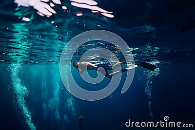 Man free diver swimming in ocean, underwater photo with diver Stock Photo
