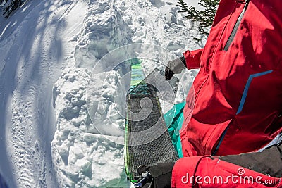 Man freerider installs glue camus on skis, in snow wild mountains Stock Photo