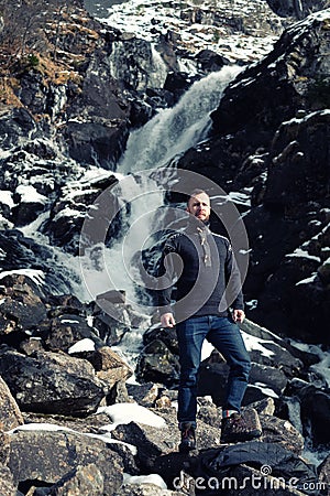Man in front of Latefossen waterfall in winter, Norway Stock Photo