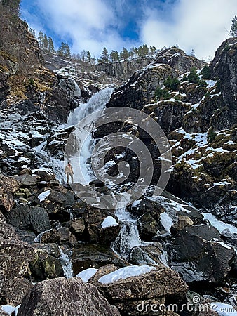 Man in front of Latefossen waterfall in winter, Norway Stock Photo