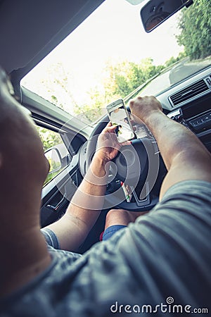 Distracted man traveling and photographing while reckless driving Stock Photo