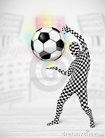 Man in full body suit holdig soccer ball Stock Photo