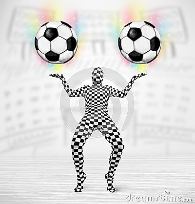 Man in full body suit holdig soccer ball Stock Photo