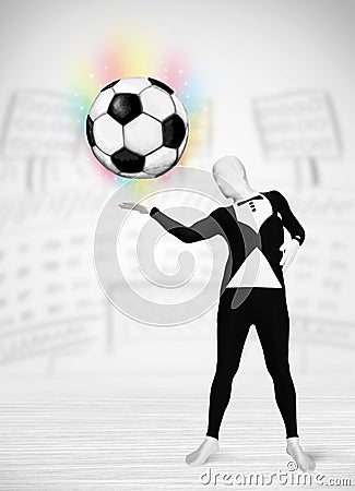 Man in full body suit holdig soccer ball Stock Photo