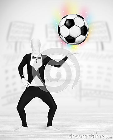 Man in full body suit holdig soccer ball Stock Photo