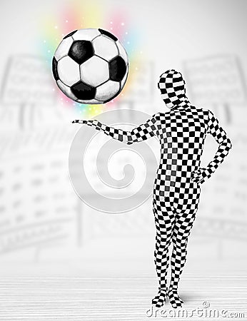 Man in full body suit holdig soccer ball Stock Photo