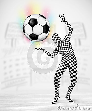Man in full body suit holdig soccer ball Stock Photo