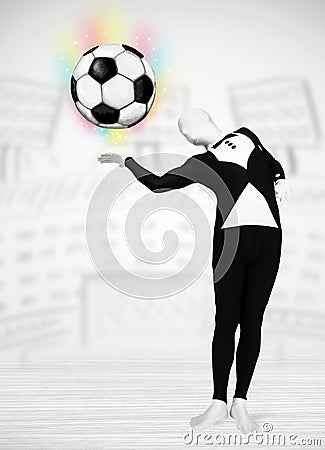 Man in full body suit holdig soccer ball Stock Photo