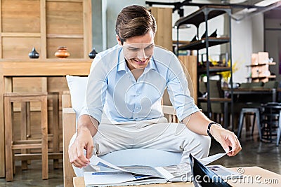 Man in furniture store browsing catalog Stock Photo