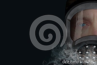 Man in gas mask portrait. Closeup half face view on gray background with smoke. Concept of chemical, epidemic, ecology or Stock Photo