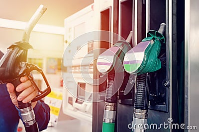 man at the gas station filling the tank of his car with diesel to the top level before a long journey Stock Photo