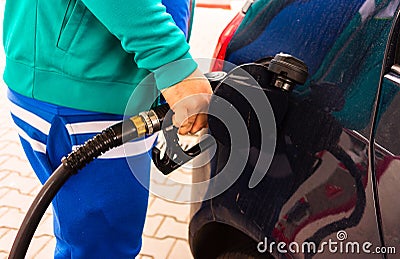 Man at gas station filling up the car with petrol in Bucharest, Romania, 2020 Editorial Stock Photo