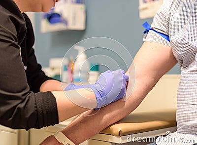 Man gets blood drawn at routine health screening Stock Photo