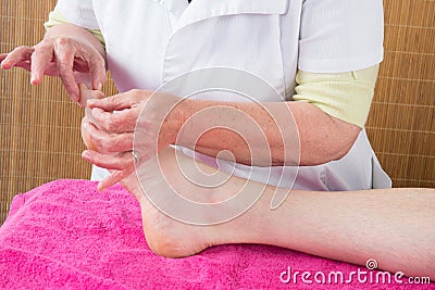 man getting acupuncture foot treatment in closeup Stock Photo
