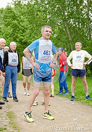 Man getting ready for running competition among elderly athletes Editorial Stock Photo