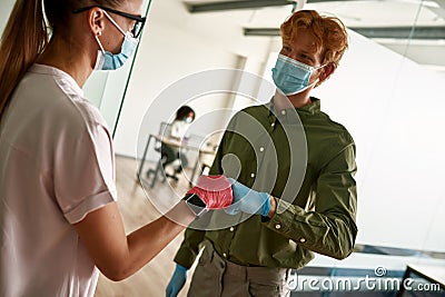 Man and girl bumping fists in medical gloves Stock Photo