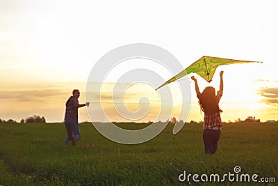 A man with a girl launches a kite Stock Photo