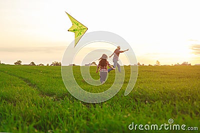 A man with a girl launches a kite Stock Photo