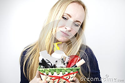 A man gives a beautiful girl a gift - a basket with cosmetics and hygiene products. Pleasant surprise for Birthday, Valentine`s Stock Photo