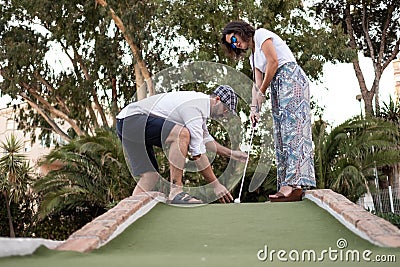 Man giving golf lesson to a woman Stock Photo