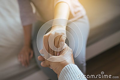 Man giving hand to depressed woman,Psychiatrist holding hands patient,Meantal health care concept Stock Photo