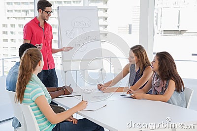 Man giving presentation to casual team in office Stock Photo