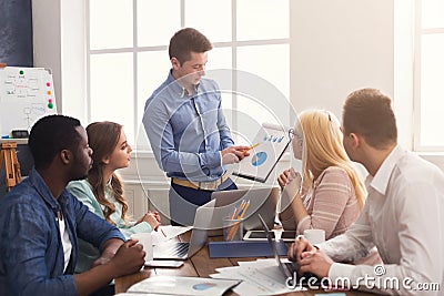Man giving presentation to colleagues in office Stock Photo