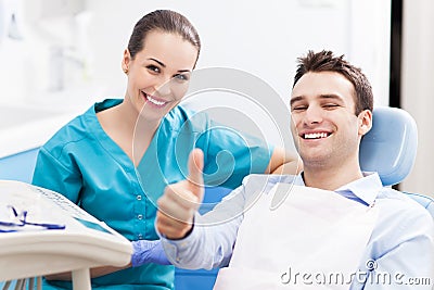 Man giving thumbs up at dentist office Stock Photo