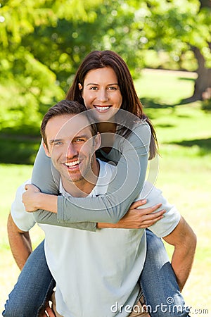 Man giving wife a piggyback Stock Photo