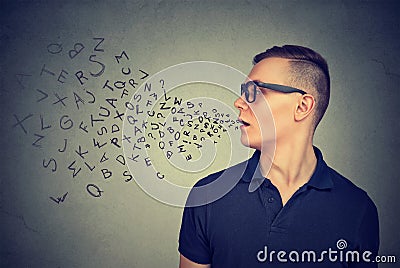 Man in glasses talking with alphabet letters coming out of his mouth. Communication concept Stock Photo