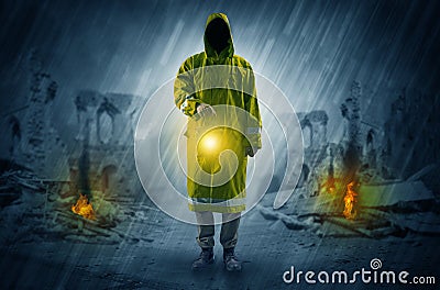 Man with a glowing lantern at a catastrophe scene Stock Photo