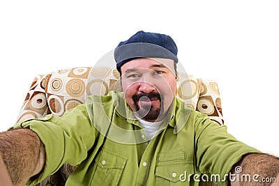 Man with goatee in armchair taking selfie Stock Photo