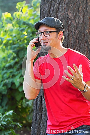 Man with goatee talking on phone Stock Photo
