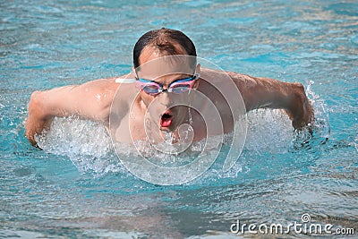 Man in goggles swimming jumped out of water Stock Photo