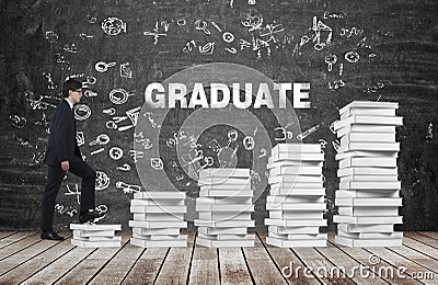 A man is going up using a stairs which are made of white books. The word graduate is on the black chalkboard. Stock Photo