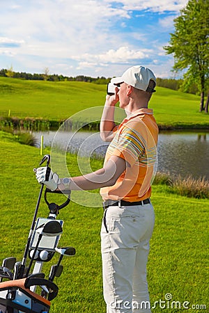 Man golfer watching into rangefinder Stock Photo