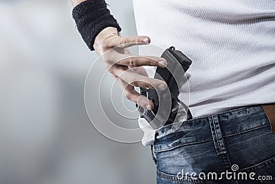 Man grabbing his pistol Stock Photo