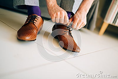 The man in gray slacks and a purple dress socks brown shoes with Stock Photo