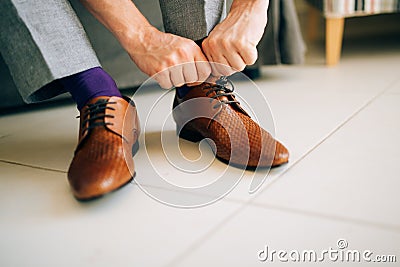 The man in gray slacks and a purple dress socks brown shoes with Stock Photo