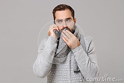 Man in gray sweater isolated on grey background. Healthy lifestyle ill sick disease treatment cold season concept. Mock Stock Photo