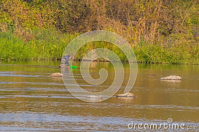 Man with greeen baske fishing in Kumgang river Editorial Stock Photo