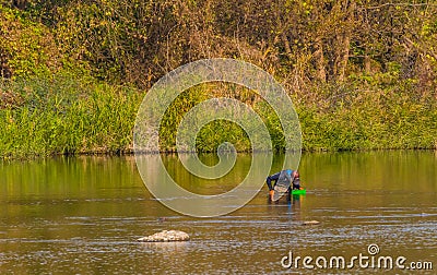 Man with green basket fishing in Kumgang river Editorial Stock Photo