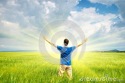 Man in green wheat meadow. Stock Photo