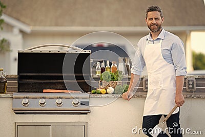 man grilling salmon fillet, advertisement. man grilling salmon fillet outdoor. Stock Photo