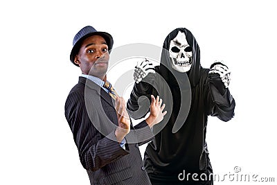 Man in Grim Reaper Ghost Costume Playing a Prank on Halloween Stock Photo