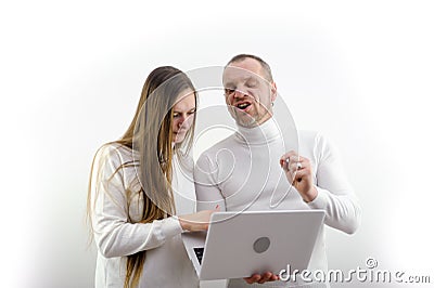 man grimaced and screams telling woman how to use laptop tells student student how to write report abstract scientific Stock Photo