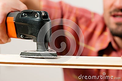 Man is grinding a plank Stock Photo