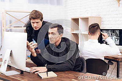 A man guard is sitting in front of the monitor. Stock Photo