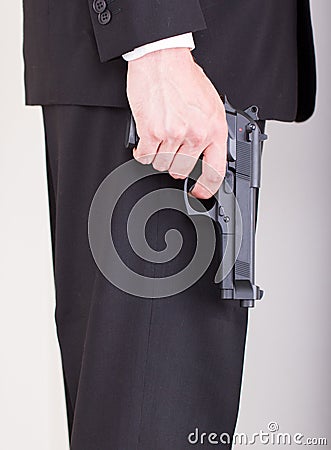 Man with gun, business suit Stock Photo
