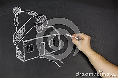 Man hand chalk with home on blackboard Stock Photo